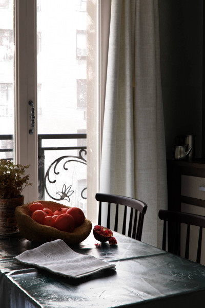 3D Pomegranate on table next to chair